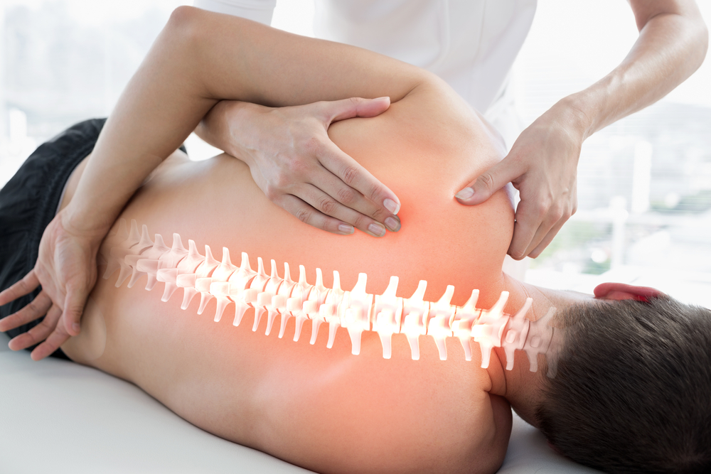 Patient getting chiropractic adjustment - lighted view of spine