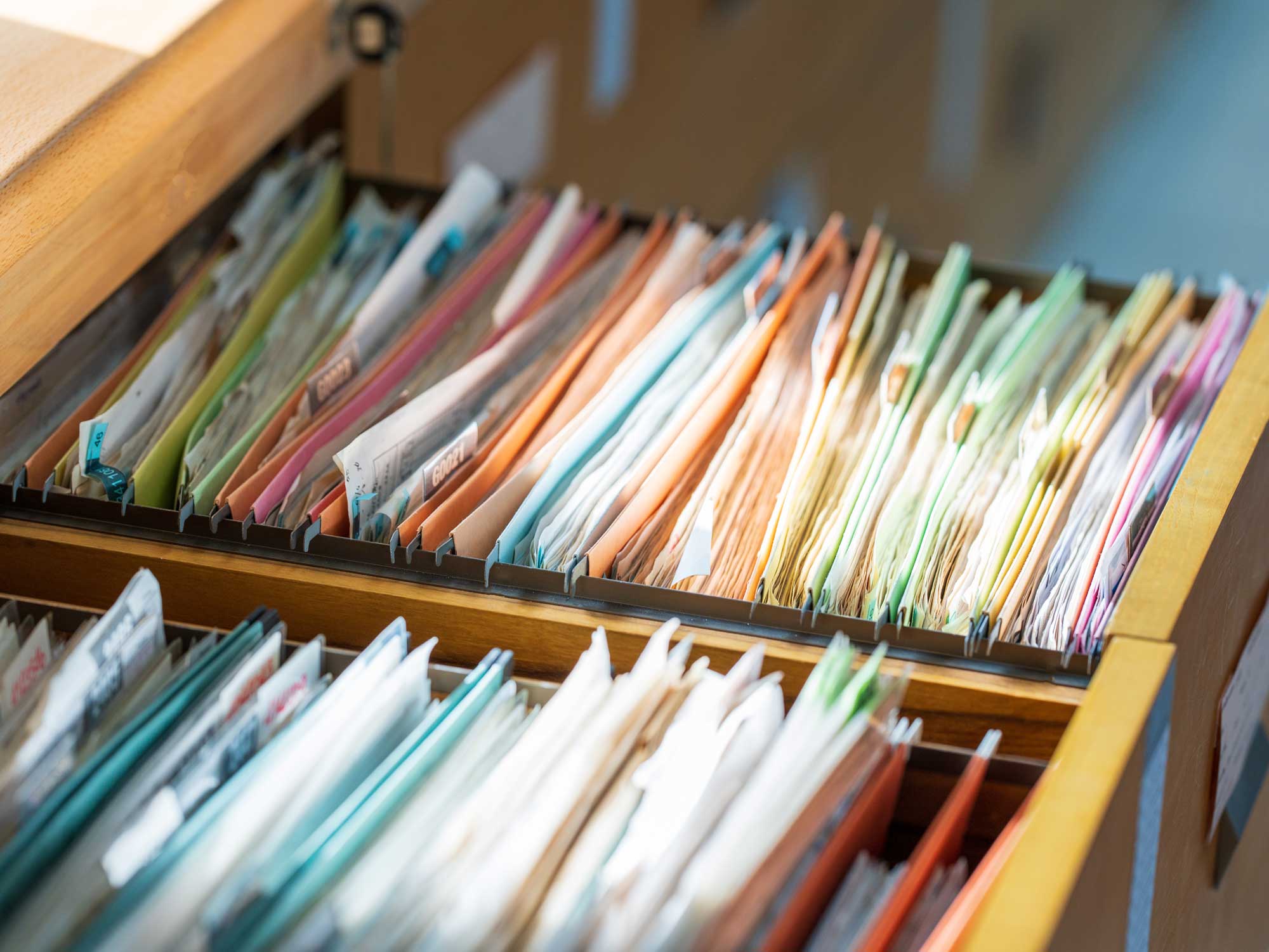 Open filing cabinet full of patient charts.